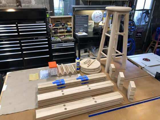 Workshop scene with an assembled stool and parts